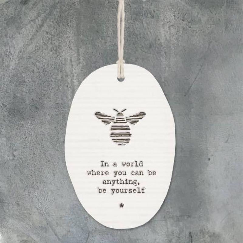 White porcelain oval tag in a world where you can be anything be yourself