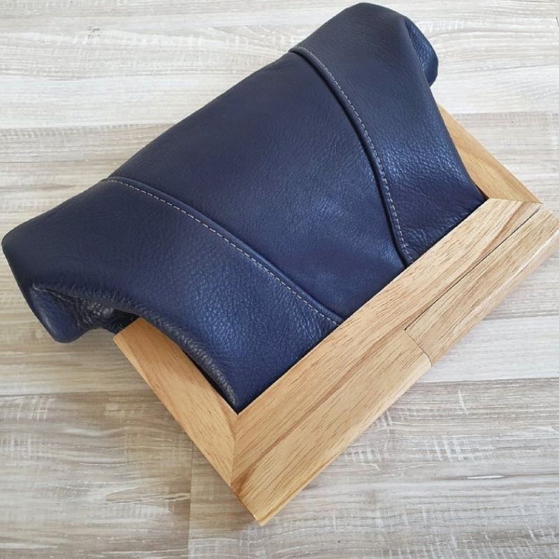 navy leather clutch with three panels and timber closure