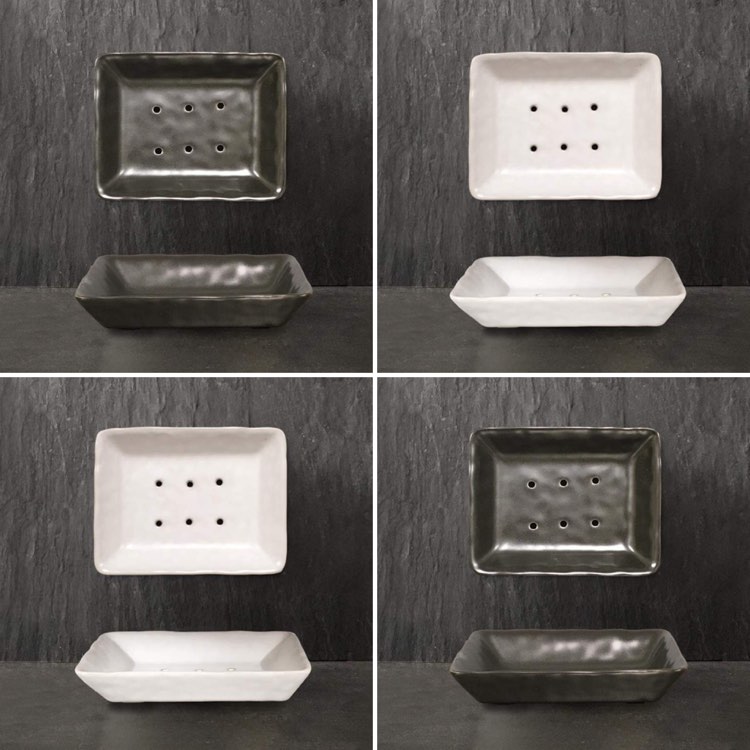 two black and two white porcelain soap dishes from East of India with six drainage holes.