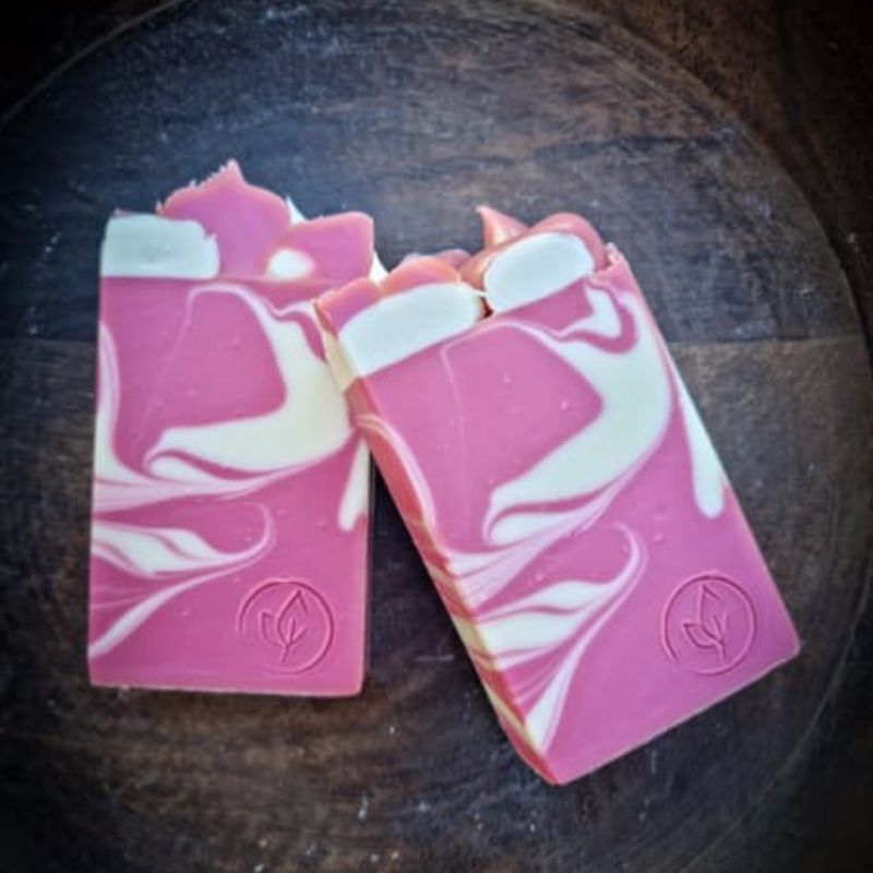 two bars of candy cane soap with pink and white swirls