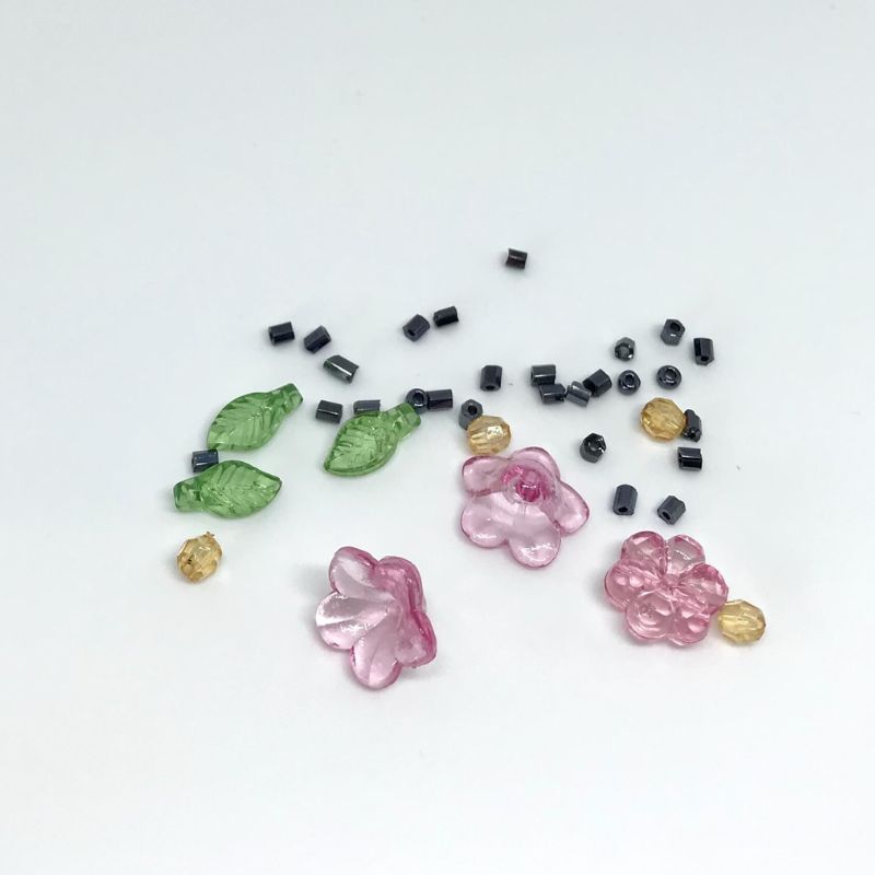 bead pack with flower shaped beads, green leaves with golden beads and black seed beads