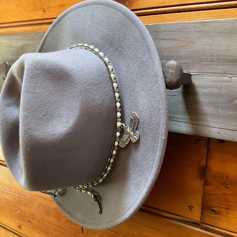 grey wool felt fedora with beads and eagle charm around crown