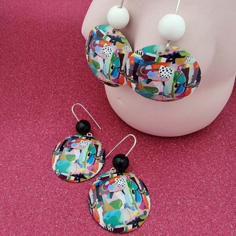 Two pairs of earring featuring 'My Humps' artwork