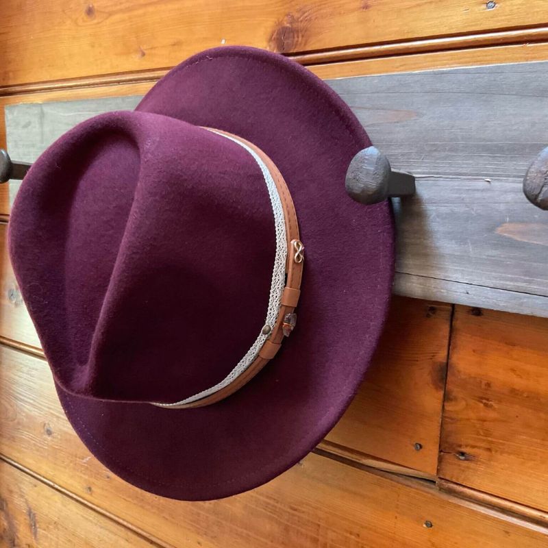 wool felt fedora in a berry colour with lace and feather around brim