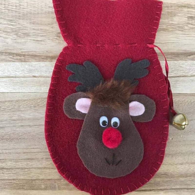 felt decoration ornament in the shape of a mitten with accented bell with a felt reindeer on the front