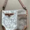 grey floral canvas bag with one half of front in a hair on leather grey shades