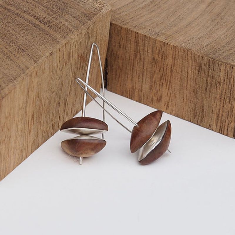 earrings two wooden pebbles with sterling silver on the inside of each sarah bourke