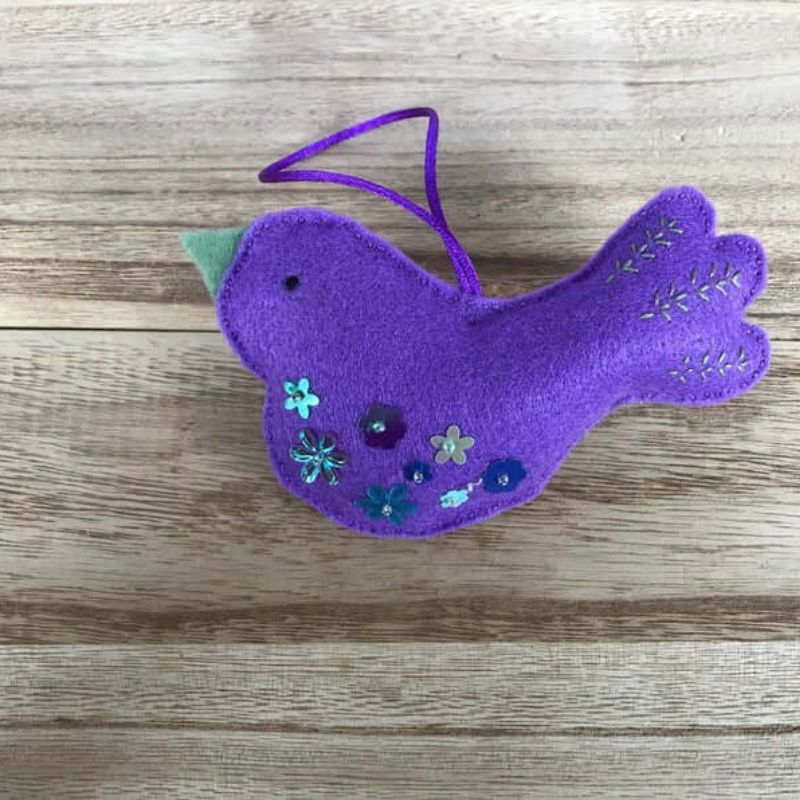 purple bird ornament with green beak and sequins