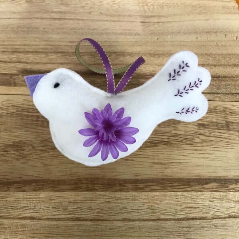 white felt bird with purple flower and embroidery