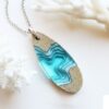resin and sand necklace with design of a fjord and made with sand and resin