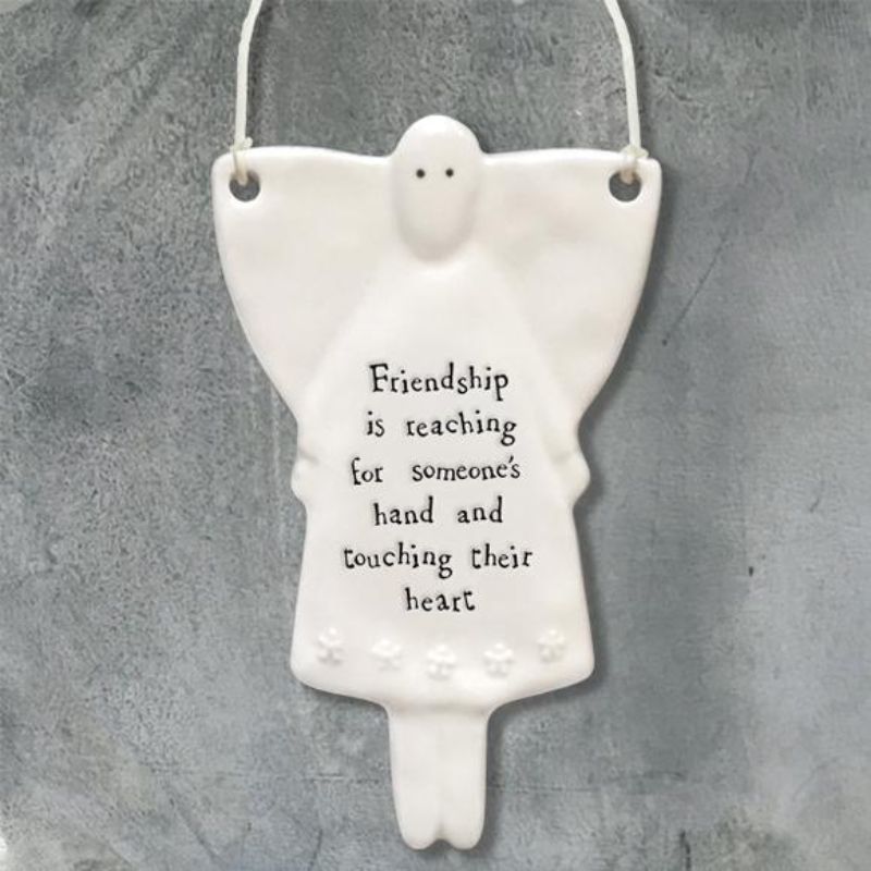 white porcelain angel ornament, friendship is reaching for someone's hand and touching their heart