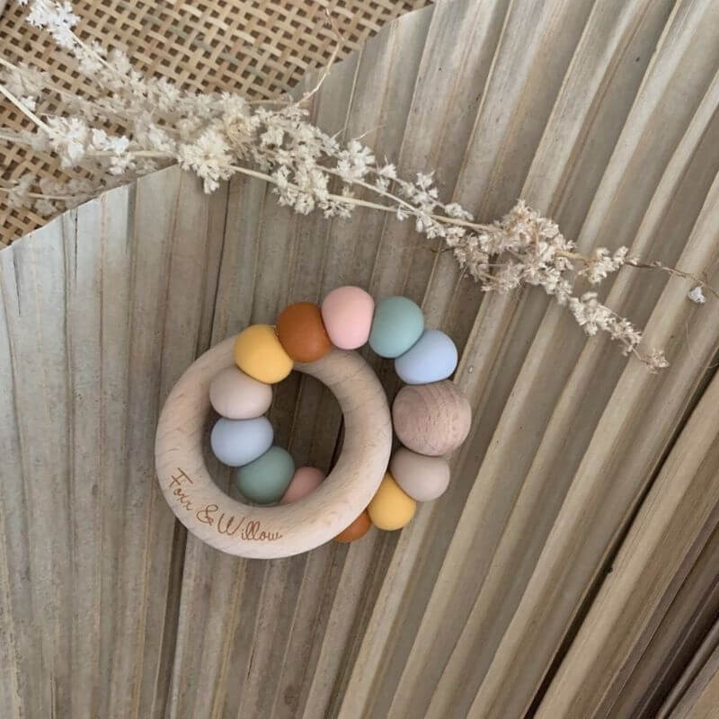 infinity teething rattle wood with silicone beads muted earthy tones