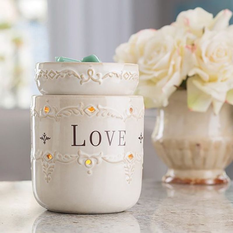 white ceramic electric candle warmer with a white ceramic warming tray and the words live love and laugh around the outside