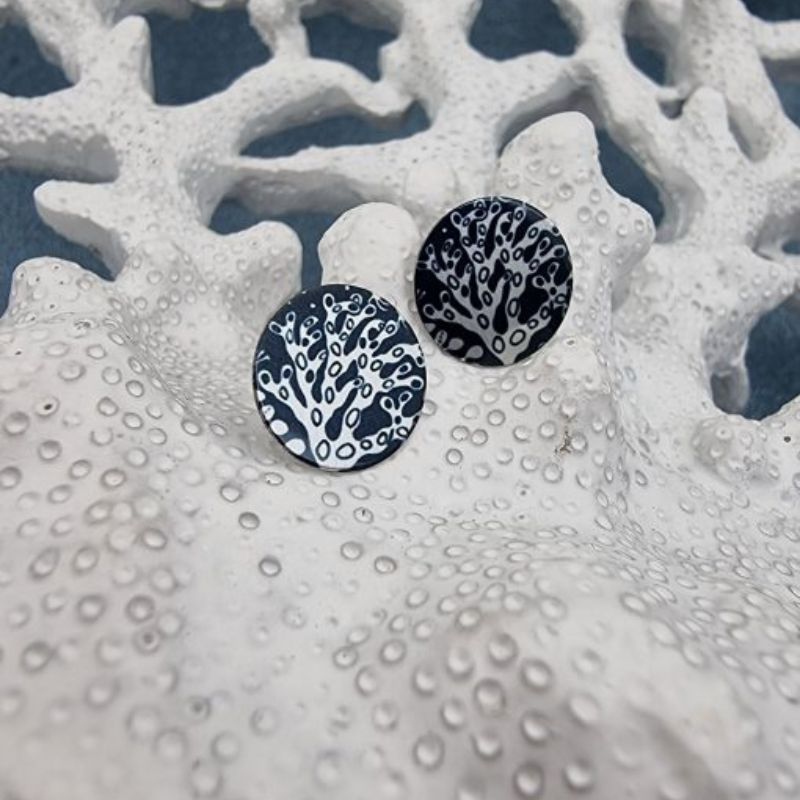 Blue stud earrings with a coral design in silver