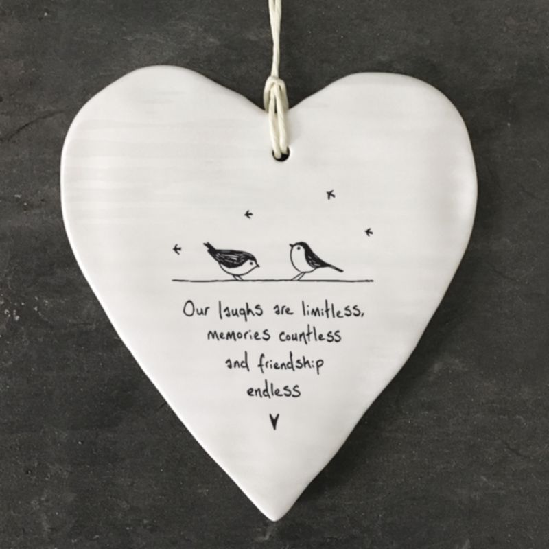 white porcelain hanging heart east of india, saying our laughs are limitless memories countless and friendship endless