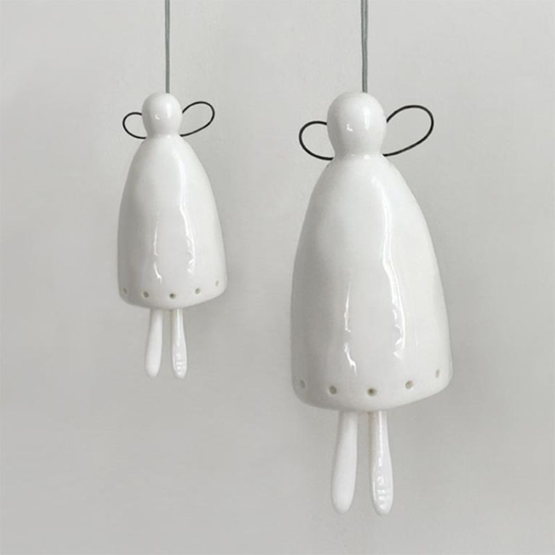 large and small white porcelain angel bells that legs clang against the body