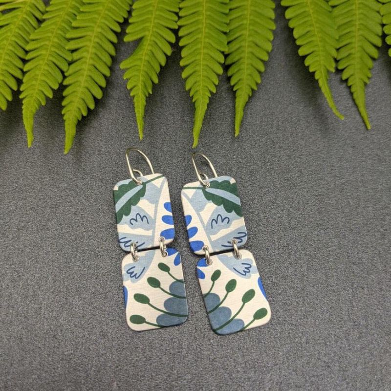 earrings featuring two aluminium rectangles with forest pattern