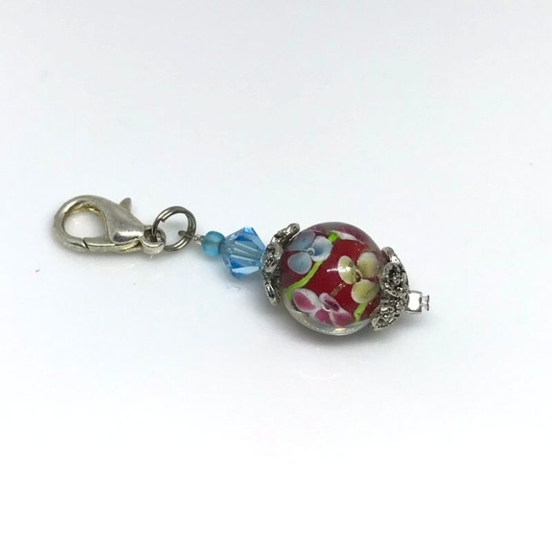 phone bag or zip dangle with red lampwork bead covered in flowers and blue Swarovski bicone bead