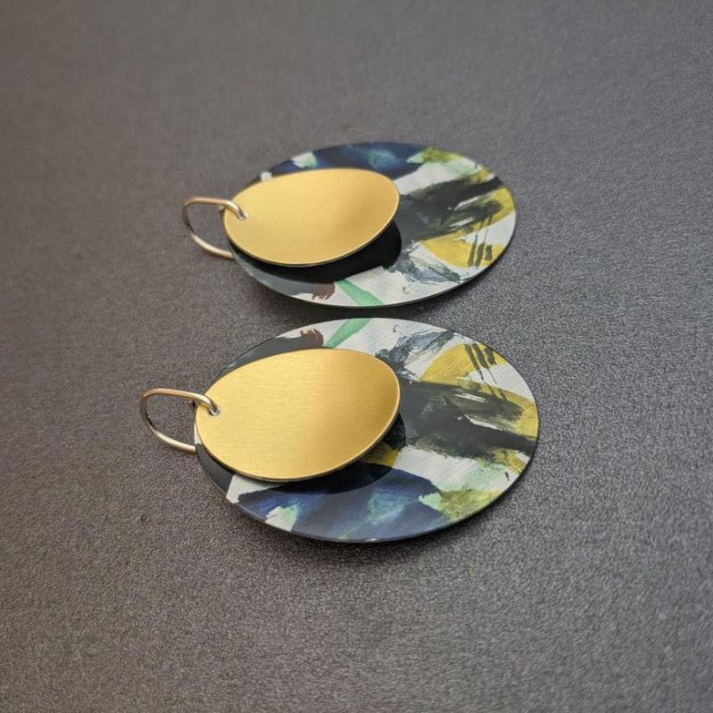 dark green black and yellow splashed earrings with gold disc tops