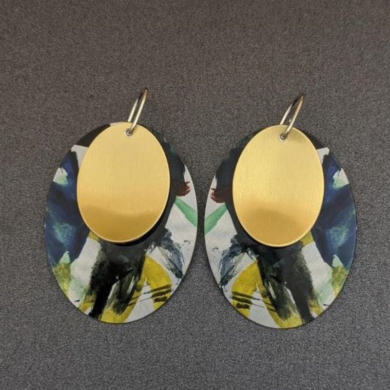 black green and yellow splashes on metal earrings with gold disc tops