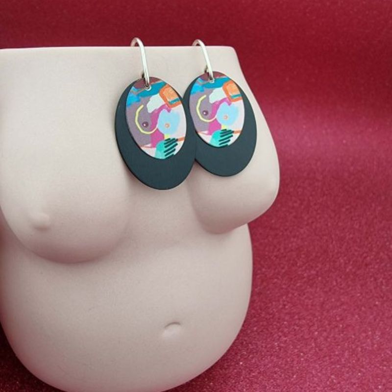 earrings with a double disc with a black disc below and my humps artwork on top