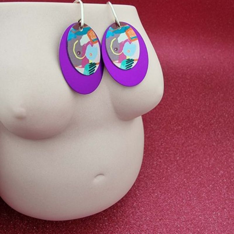 earrings with a double disc with a purple disc below and my humps artwork on top
