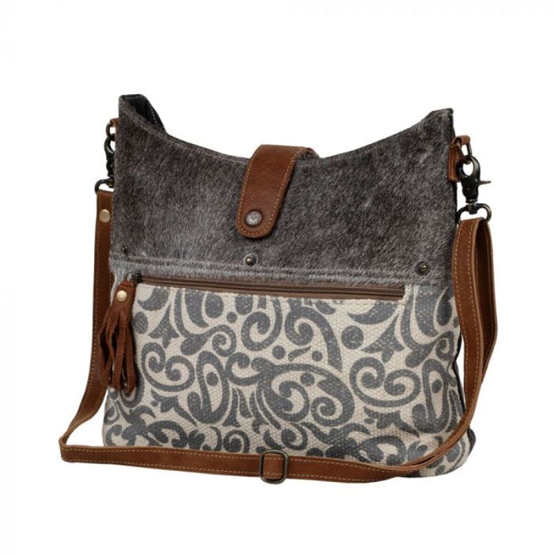 swirly grey pattern bag on the bottom half of front with other half being grey hair on leather