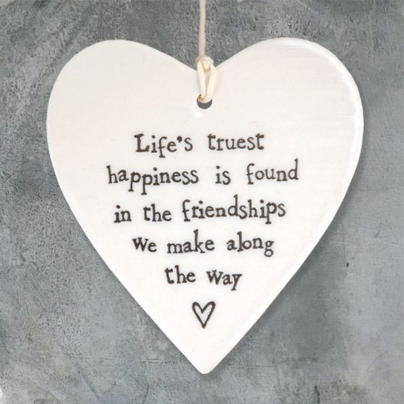 white porcelain heart with the say life's truest happiness is found in the friendships we make along the way