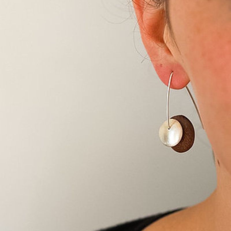 lady wearing earrings wood disc with matte finish sterling silver domed cap sarah bourke