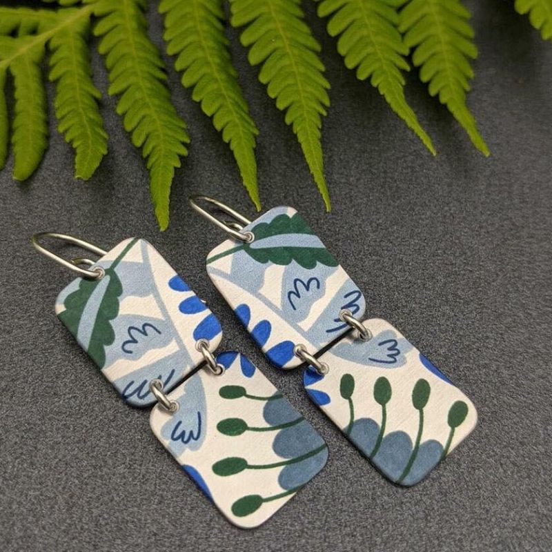 earrings featuring two aluminium rectangles with forest pattern