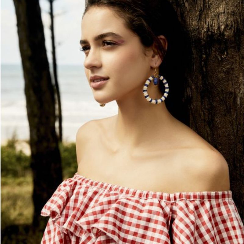Lady wearing the Blue and white beads and round gold hoop earring