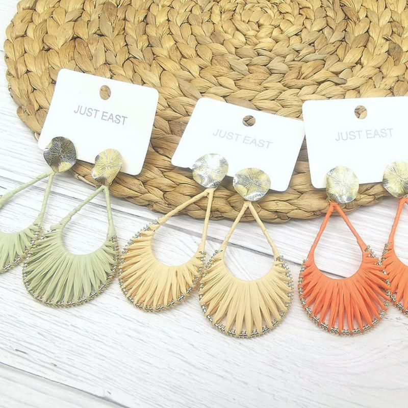 three pairs of straw dangle earrings in green, cream and orange