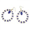 Blue and white beads adorn a round gold hoop earring