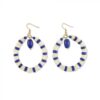 Blue and white beads adorn a round gold hoop earring