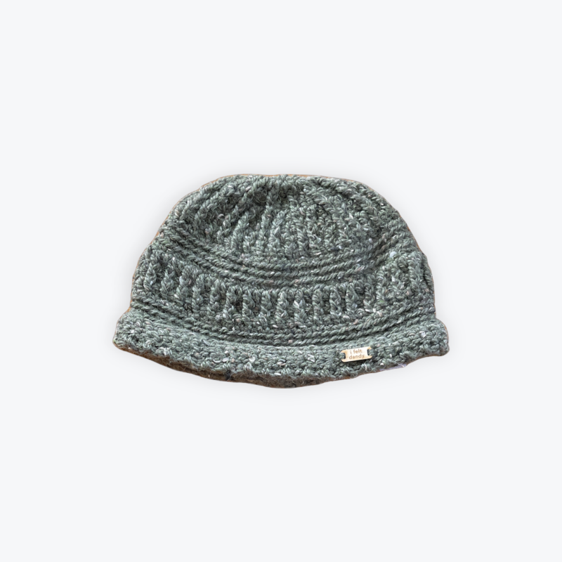 A green unisex textured cap beanie made with alpaca merino and donegal tweed.