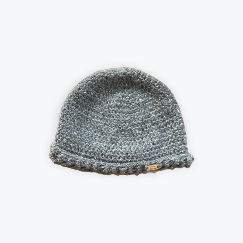 A grey unisex textured cap beanie made with alpaca merino and donegal tweed.